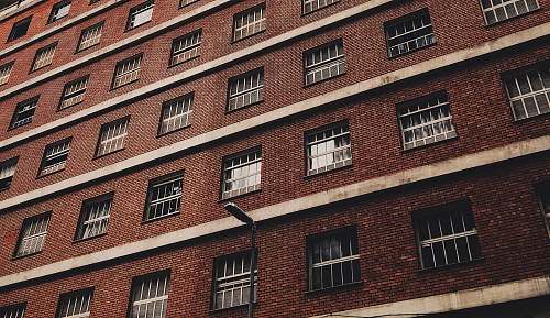 brick low-angle photography of brown concrete building city