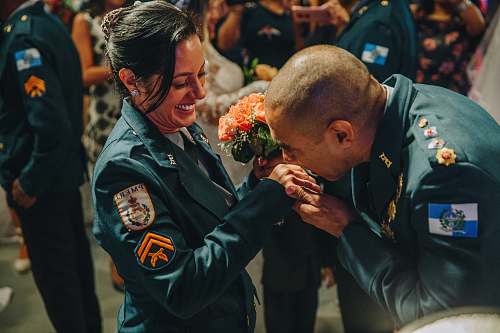 person man giving flower bouquet to a woman people