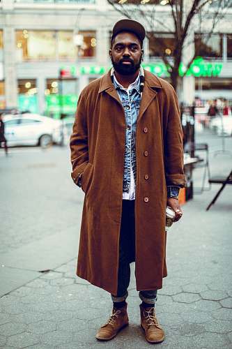 people man standing on road near bare tree coat