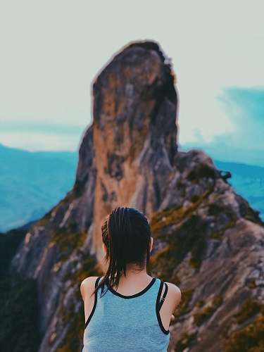 person woman looking at brown mountain woman