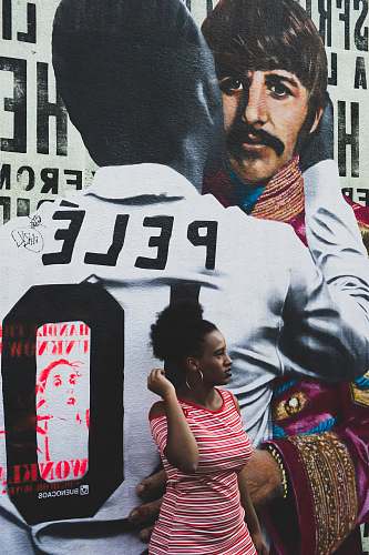 person woman standing beside Pele wall people