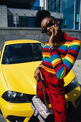 person woman standing in front of yellow car people