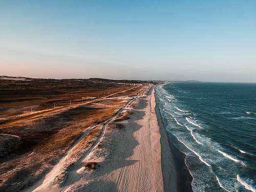 ocean aerial photo of shoreline beside body of water sea