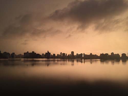 outdoors grayscale photography of city near body of water water