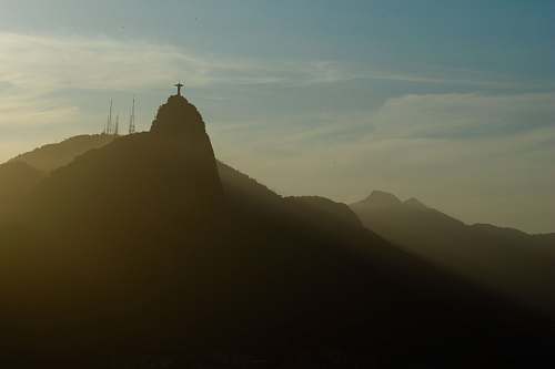 outdoors silhouette of cross on top of mountain at daytime mountain