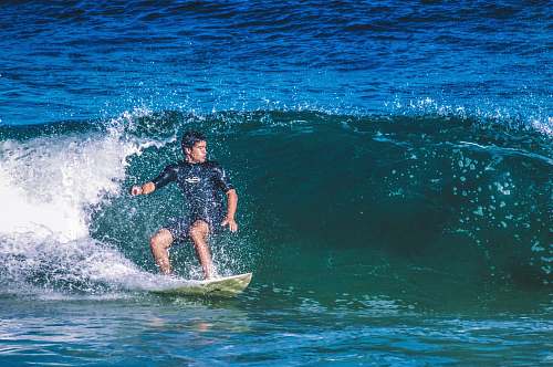 sea man playing surfboard water