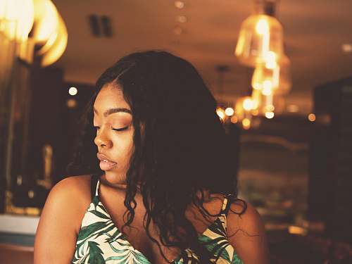 human woman wearing white and green floral spaghetti strap shirt person