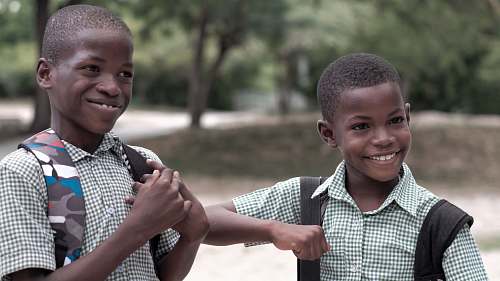 human 2 smiling boys in uniform boy
