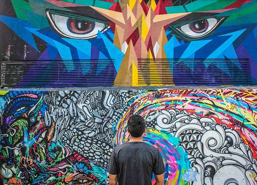 human photography of man seeing doddle wall art graffiti