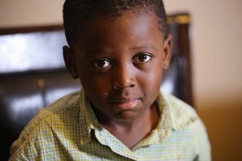 human selective-focus photography of boy wearing green plaid shirt people