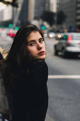 people shallow focus photography of woman with cars in background human