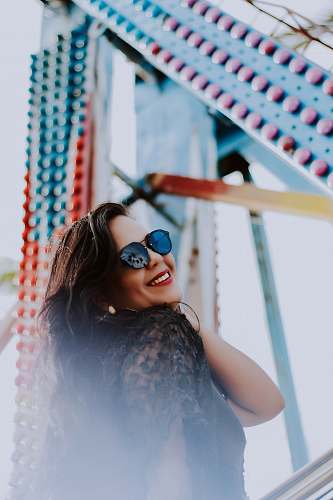 people woman standing near blue and red concrete structure during daytime human
