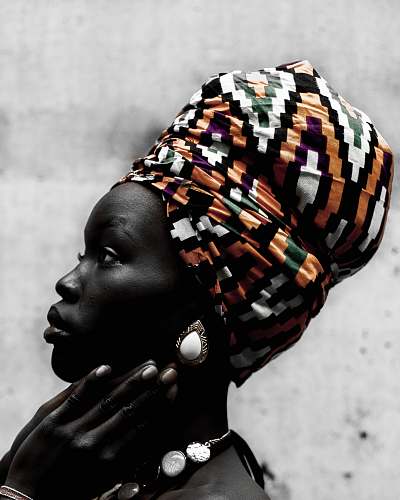 black person with orange and white headdress people