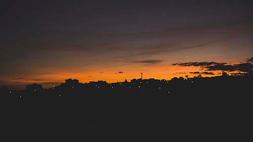 sunset aerial photography of silhouette of city sky