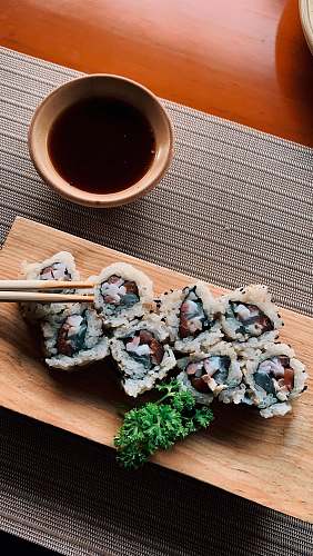 sushi brown and white dish on brown wooden chopping board japan