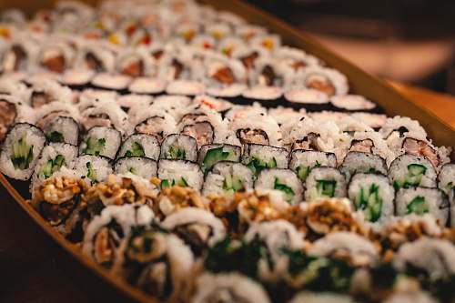 sushi green and white vegetable on brown wooden tray sashimi