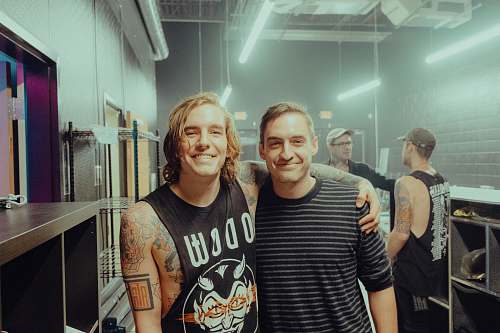 person two man standing near shelf tattoo