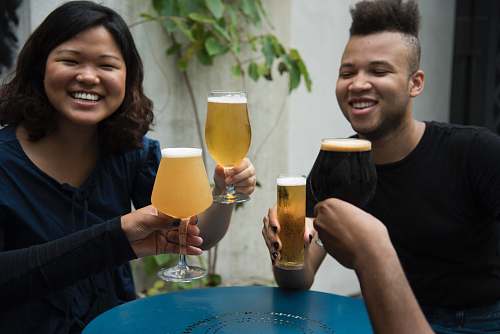 human group of people holding drink-filled glasses person