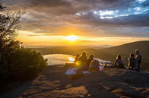 group group of people sirring under sunset friend
