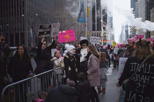 human group of people standing near buildings during daytime person