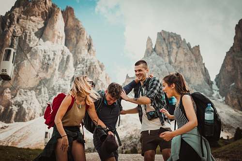 person low-angle photography of two men playing beside two women human