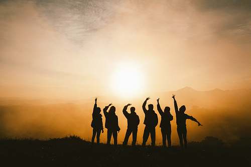 group silhouette photo of six persons on top of mountain friends