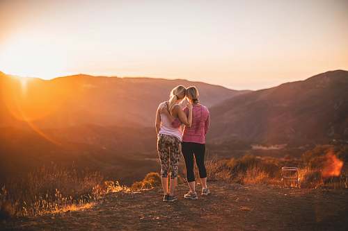 human two women standing on moutain woman