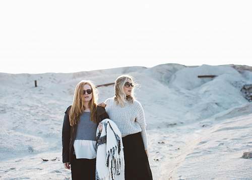 human two women standing on snow covered surface person