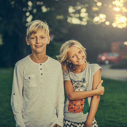 people girl and boy standing on green grass field human