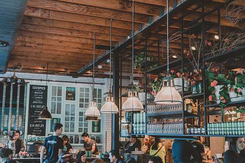 cafe man standing near table friends