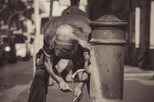 person grayscale photography of person docking outdoor animal