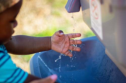 human boy washing hands with water washing