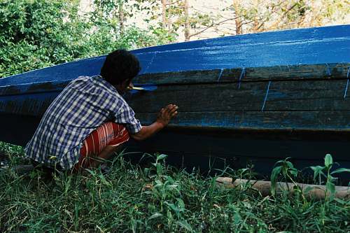 human man painting boat myanmar