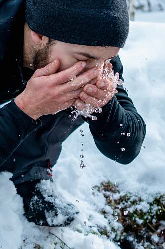 human man washing his face at the snowfield washing