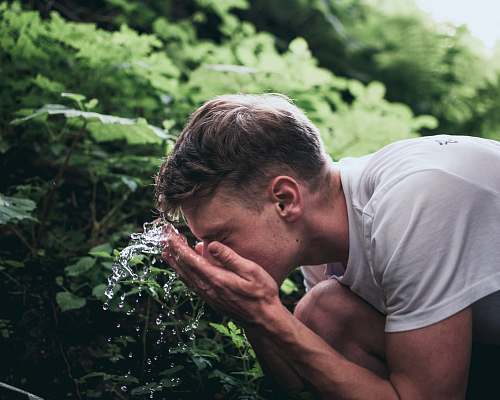 human man washing his face people