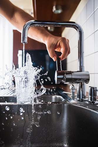 human person opening faucet sink faucet