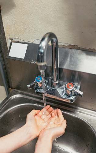 human person washing hand on stainless steel faucet sink faucet