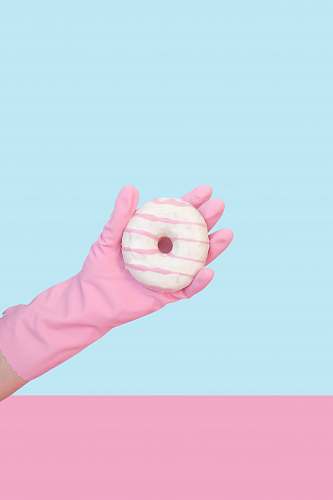 food person holding doughnut with cream donut