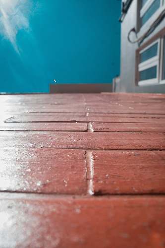 hardwood red bricked floor near blue painted wall flooring