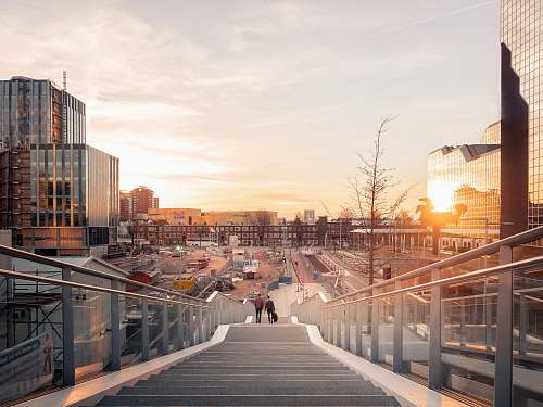 building architectural structure photography of two people on stairs near buildings utrecht