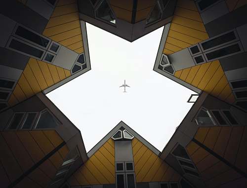 rotterdam worm's eye view of building showing airplane in the sky building