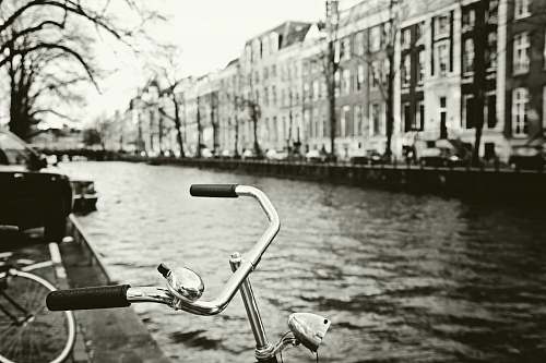 outdoors grayscale photo of bicycle canal