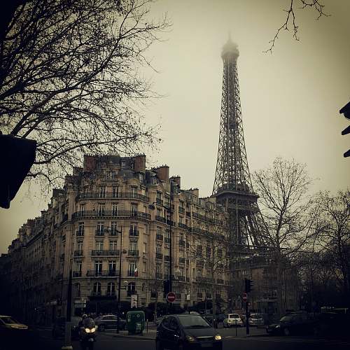 building Eiffel Tower behind concrete building tower