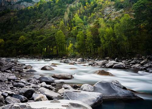 stream timelapse photograph of rocky river water