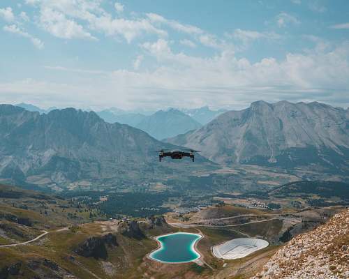nature lake in the middle of mountains during daytime outdoors