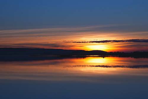 france body of water under sunset sunset