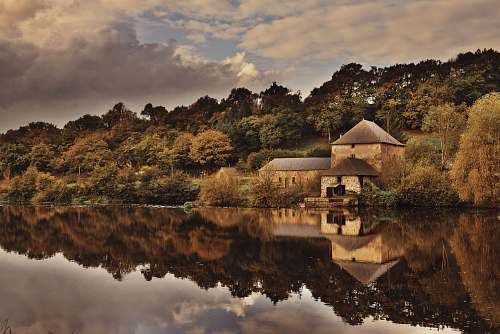 outdoors concrete house beside lake water