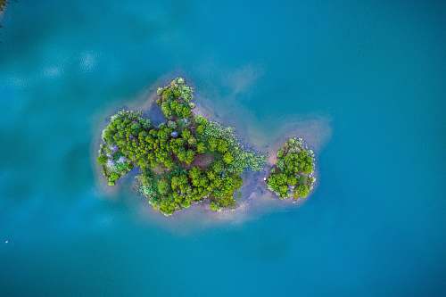 sea green island surrounded by body of water water