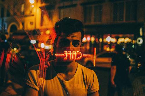 france man looking on glass at nighttime human