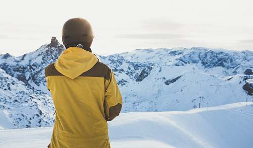 human man facing snow covered mountain people